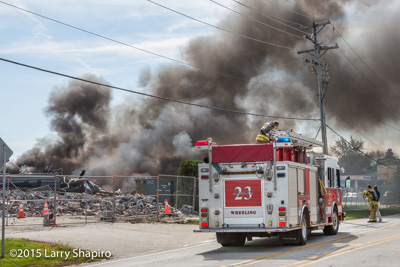 Wheeling IL firefighters extinghuish a large rubbish fire at 1760 W Hintz Road 9-25-15 the site of ongoing demolition Larry Shapiro photographer shapirophotography.net